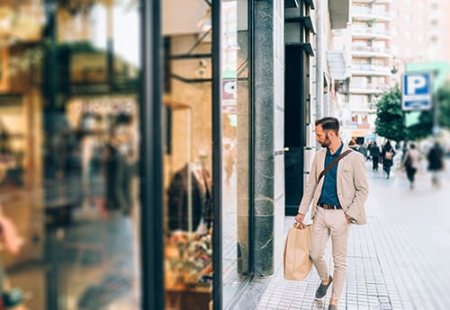 photo of a consumer looking into a retail show window